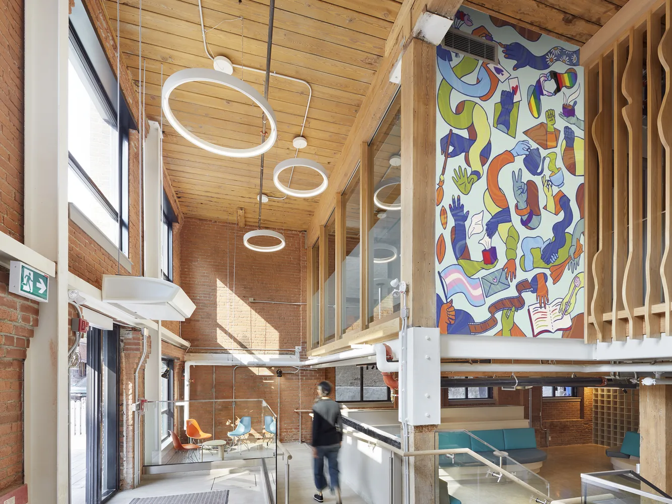 Interior with circular pendant lights, a timber ceiling and a colourful mural